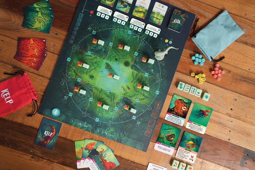 Plateau du jeu de société Kelp de couleur verte avec le pion du requin.
